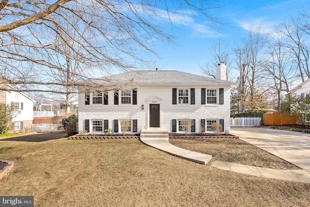 split foyer home with a front lawn