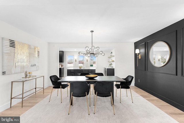 dining area with an inviting chandelier and light wood-type flooring