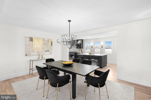 dining area featuring a chandelier and light hardwood / wood-style flooring