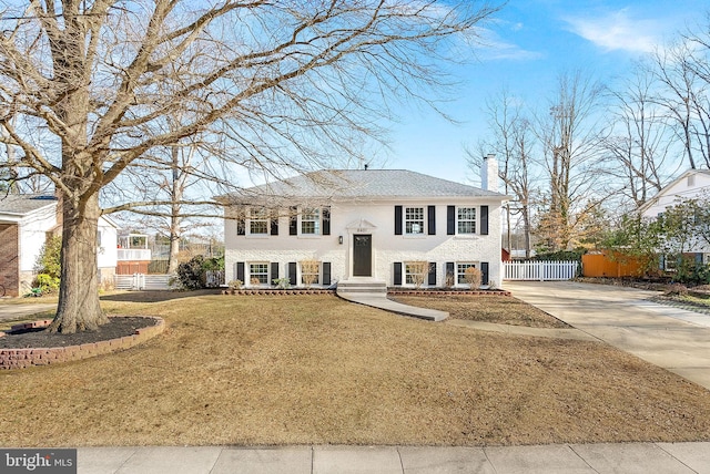 raised ranch with a front yard