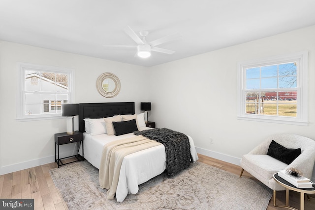 bedroom with ceiling fan and hardwood / wood-style floors