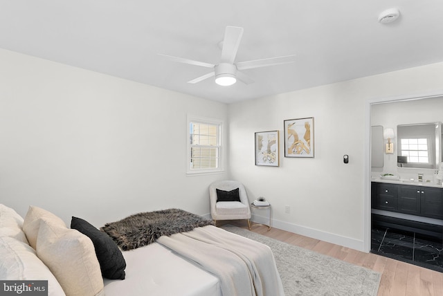 bedroom featuring hardwood / wood-style flooring and ensuite bathroom