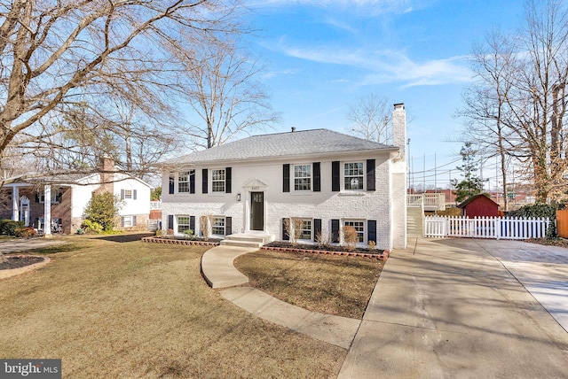 bi-level home with a front lawn