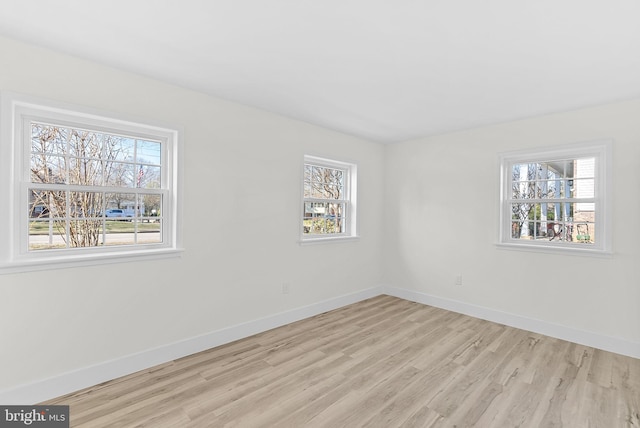 unfurnished room with light hardwood / wood-style floors