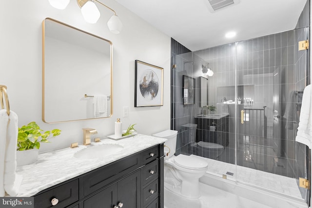 bathroom featuring vanity, toilet, and a shower with door