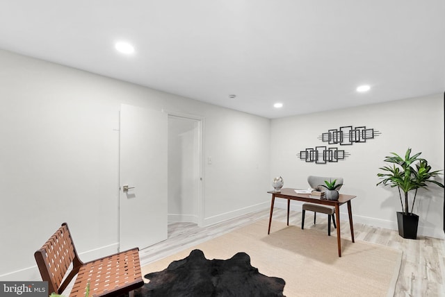 office area with light hardwood / wood-style floors