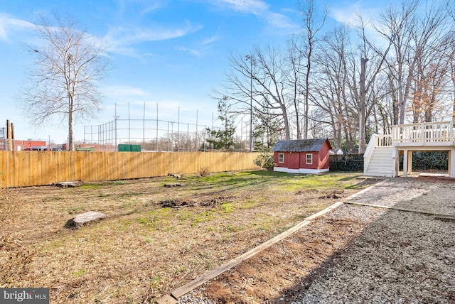 view of yard with a deck and a shed