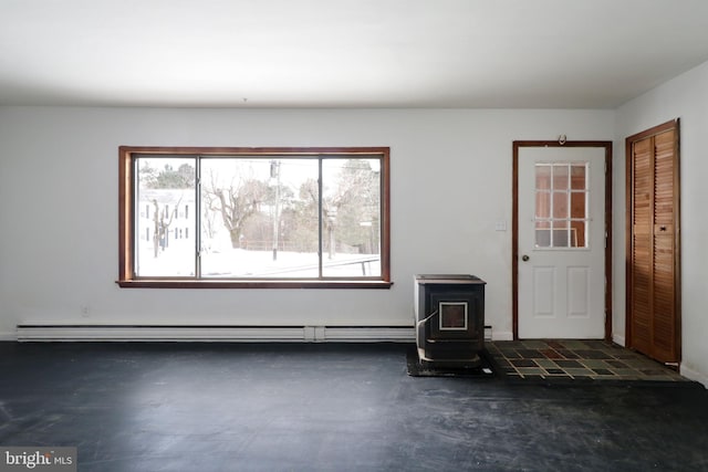 interior space with a baseboard radiator and a wood stove