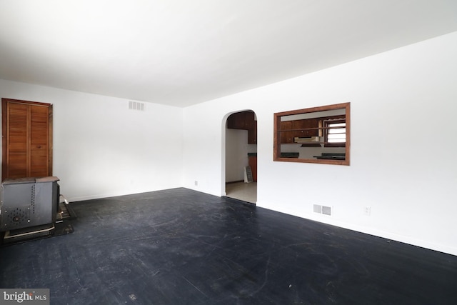 unfurnished living room featuring concrete floors