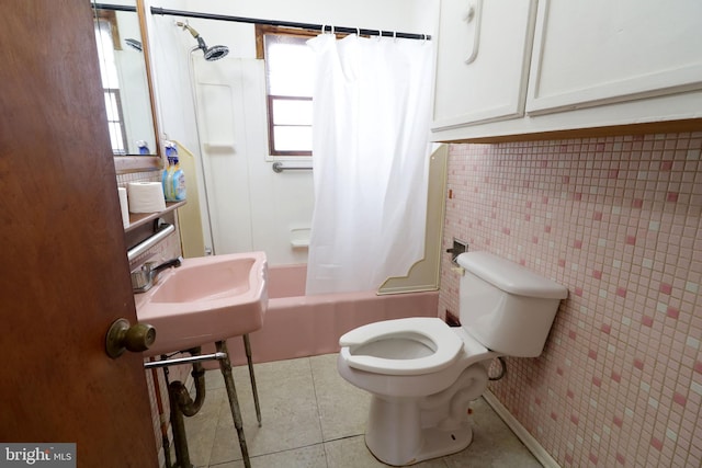 bathroom featuring shower / tub combo with curtain, tile patterned floors, and toilet