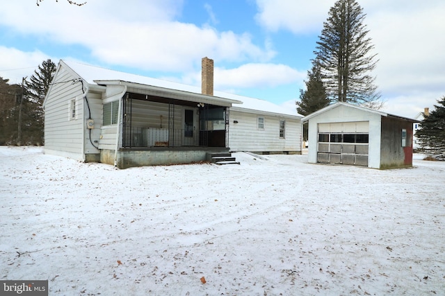 view of front of property with a garage and an outdoor structure