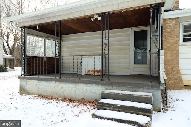 view of snow covered property entrance