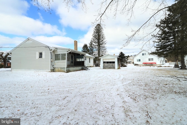 exterior space featuring a garage and an outbuilding