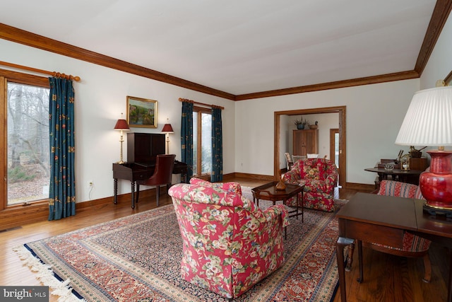 living room with baseboards, wood finished floors, and crown molding