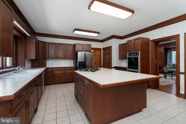 kitchen with a kitchen island, appliances with stainless steel finishes, wallpapered walls, and light countertops