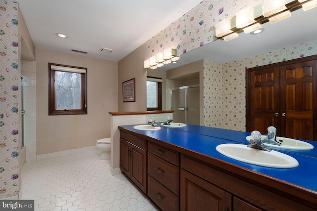 full bathroom with a sink, visible vents, a stall shower, and wallpapered walls