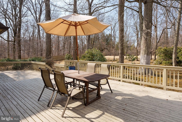 wooden terrace featuring outdoor dining space