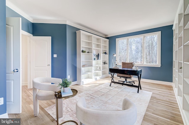 office space with ornamental molding, light wood-style flooring, and baseboards