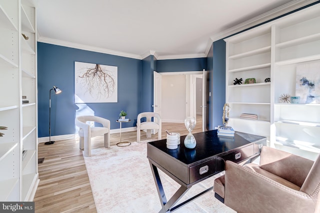 interior space featuring baseboards, light wood-type flooring, and crown molding