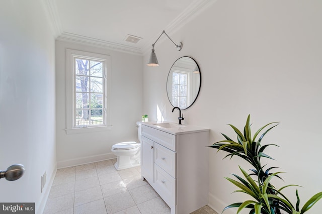 bathroom with toilet, vanity, baseboards, ornamental molding, and tile patterned floors