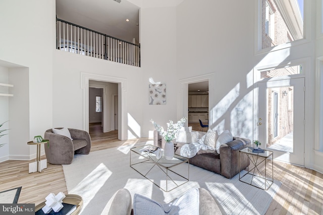 living room featuring baseboards and light wood finished floors