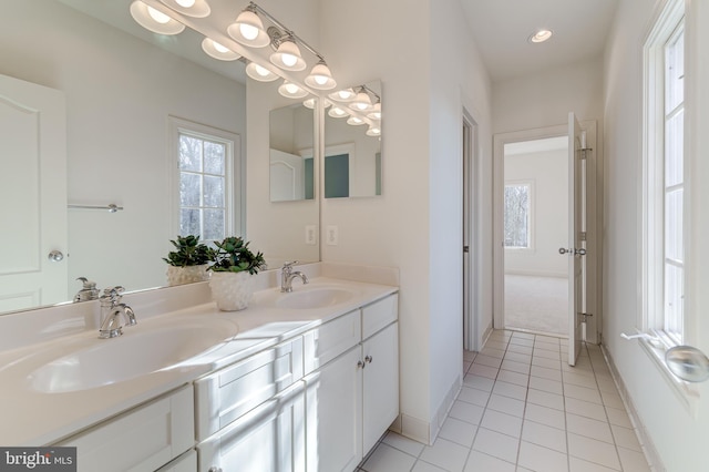 bathroom featuring a wealth of natural light, a sink, and double vanity