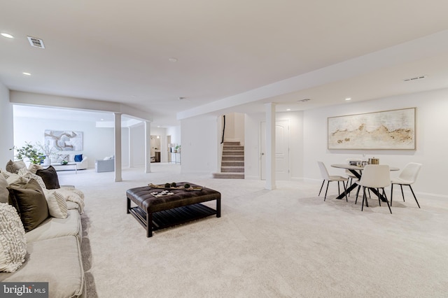 living area featuring recessed lighting, visible vents, light carpet, baseboards, and stairs