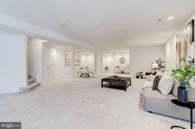 living area with light carpet, stairs, visible vents, and recessed lighting