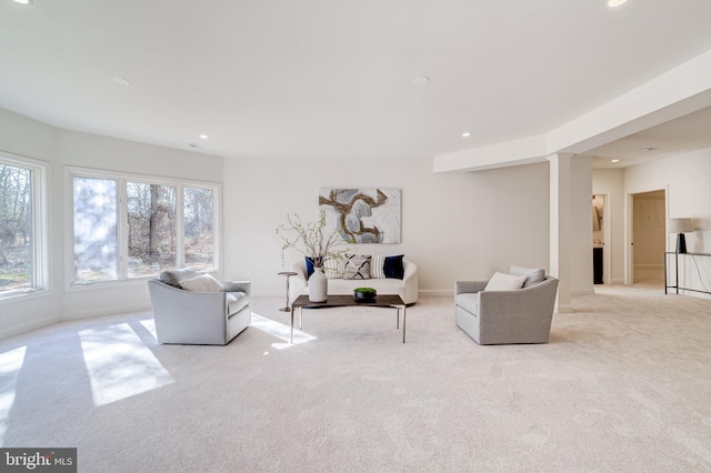 living room with recessed lighting and light carpet