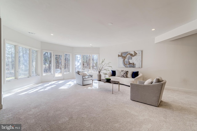 living area featuring recessed lighting, light colored carpet, visible vents, and baseboards