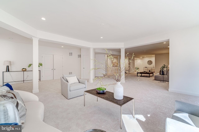 living room featuring recessed lighting, light carpet, and ornate columns