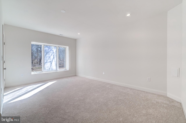 empty room with recessed lighting, baseboards, and light colored carpet