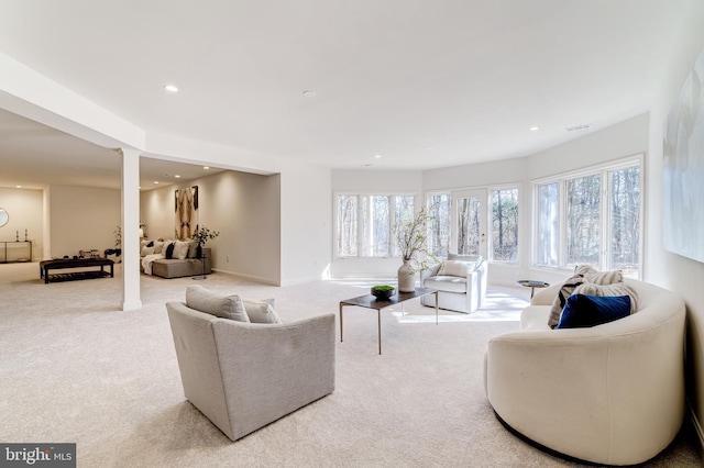 living room featuring baseboards, recessed lighting, carpet flooring, and a healthy amount of sunlight