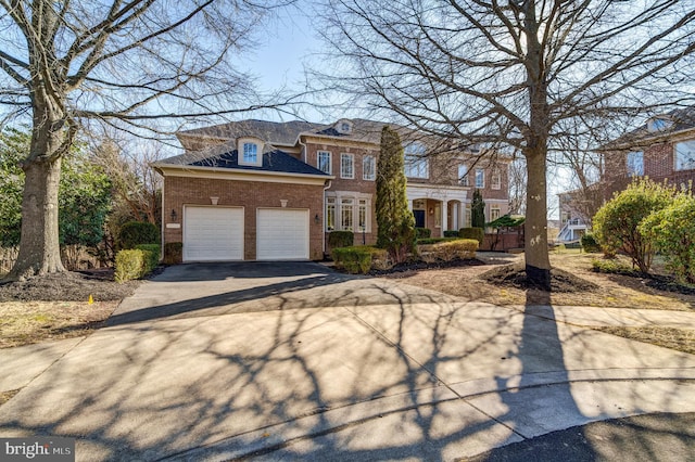 view of front facade featuring driveway, brick siding, and an attached garage