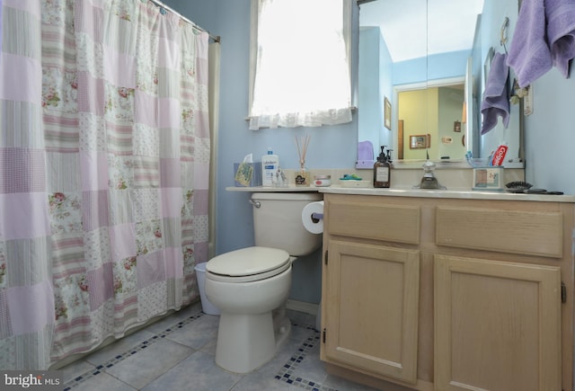 bathroom with tile patterned flooring, vanity, curtained shower, and toilet