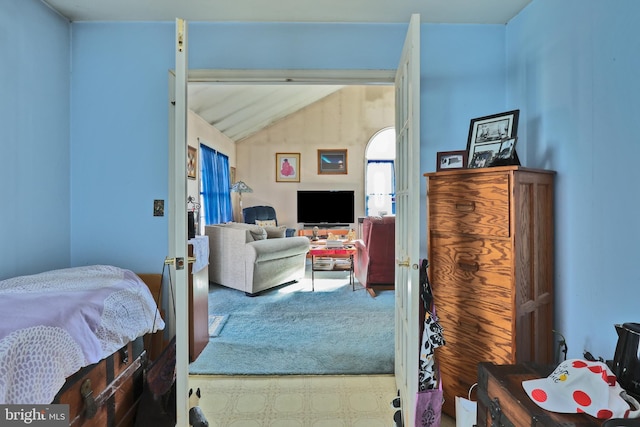 carpeted bedroom featuring lofted ceiling