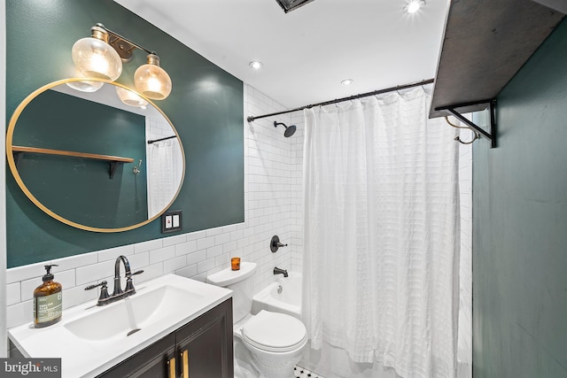 full bathroom featuring vanity, toilet, shower / bath combo with shower curtain, and tile walls