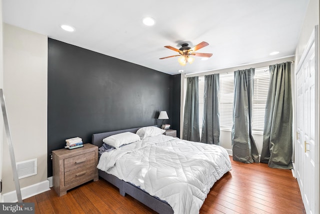 bedroom with hardwood / wood-style floors and ceiling fan