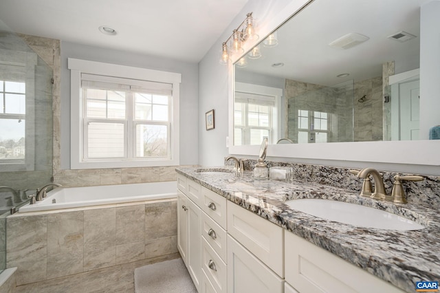 bathroom featuring plus walk in shower and vanity