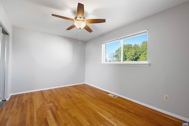 unfurnished room featuring hardwood / wood-style floors and ceiling fan