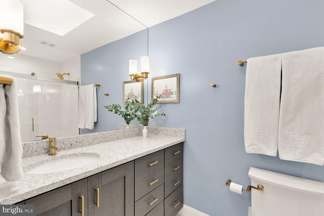 full bathroom with a skylight, visible vents, toilet, a shower stall, and vanity