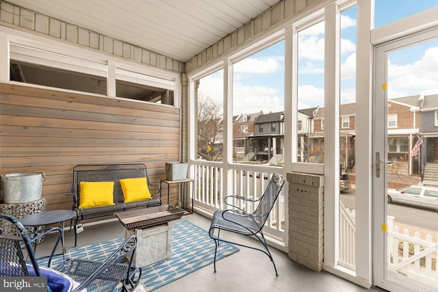 sunroom featuring a residential view