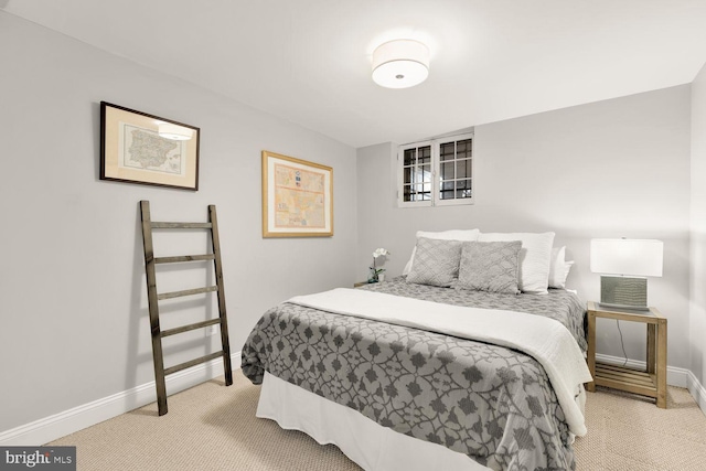 bedroom featuring light carpet and baseboards