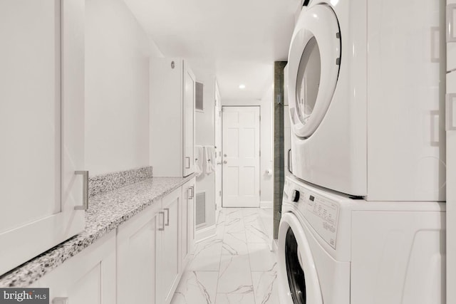 laundry room featuring laundry area, visible vents, stacked washer and clothes dryer, marble finish floor, and recessed lighting