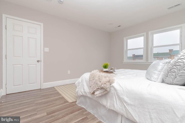 bedroom with light hardwood / wood-style floors