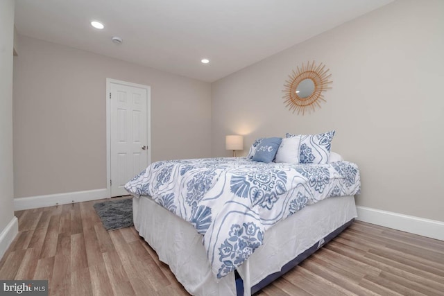 bedroom with hardwood / wood-style flooring