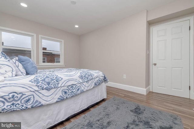 bedroom with hardwood / wood-style flooring