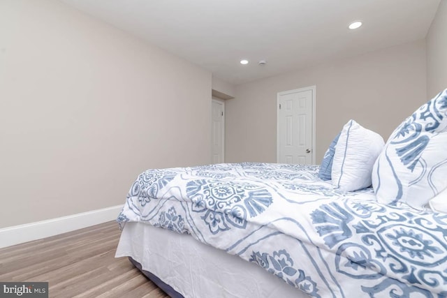 bedroom with hardwood / wood-style flooring