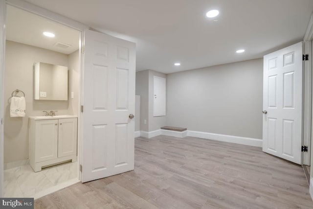 interior space with sink and light wood-type flooring