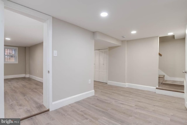 basement with light hardwood / wood-style floors